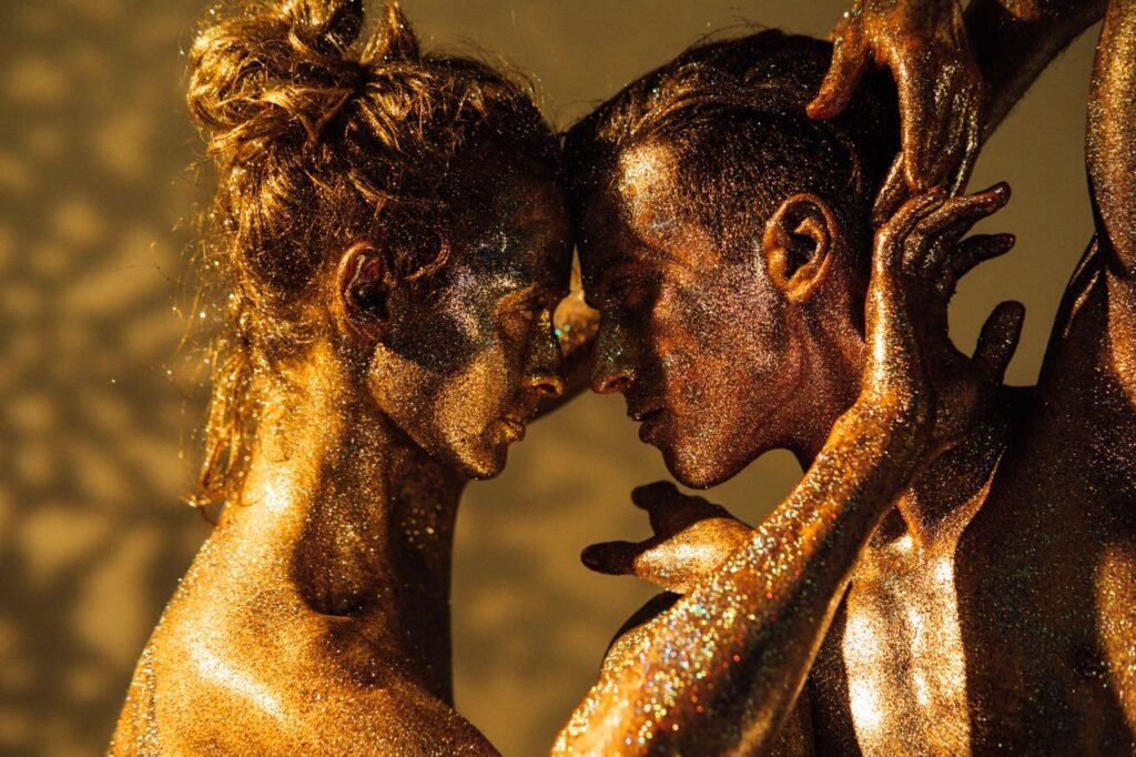 Emotive portrait of a glitter-covered couple expressing intimacy and connection.